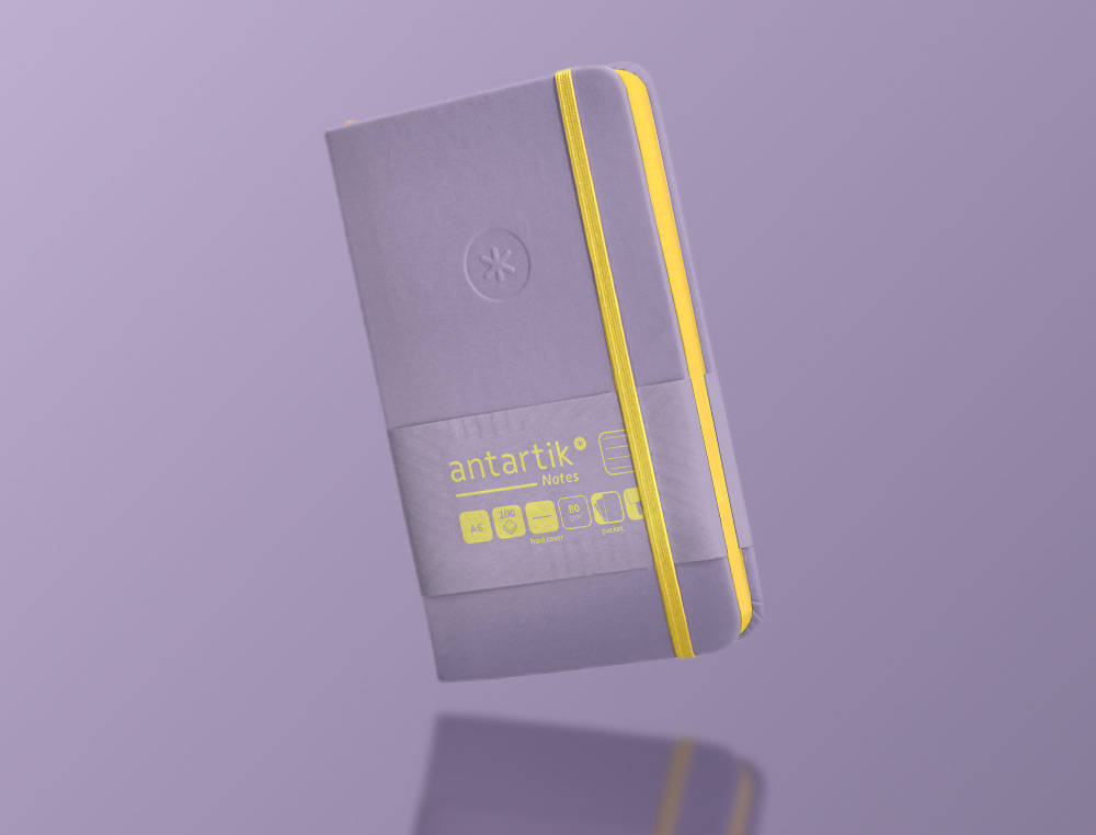 CADERNO COM ELASTICO ANTARTIK NOTES CAPA DURA A6 PAUTADO ROXO E AMARELO 100 FOLHAS 80 GR FSC